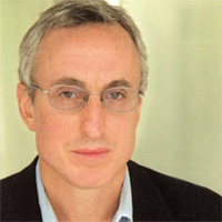 Gary Taubes Gary Taubes wearing a suit and tie smiling at the camera