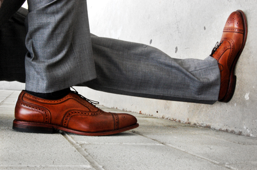 Allen Edmonds Strand A pair of feet wearing brown shoes