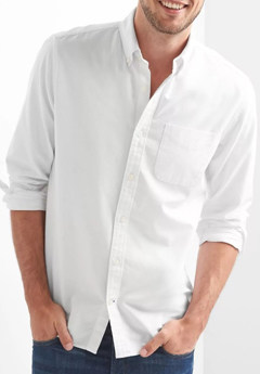 A person posing for the camera in a white shirt