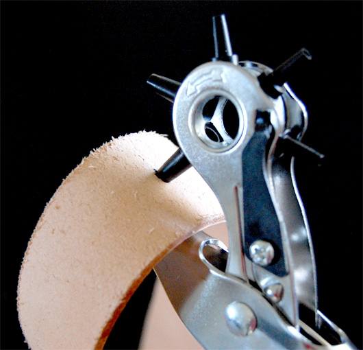 hole punch leather belt Using a leather punch to create a hole in a belt