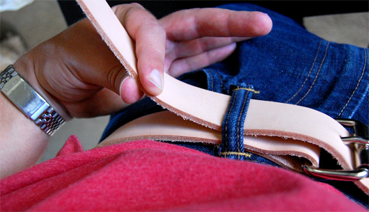 make a leather belt Hand holding long belt