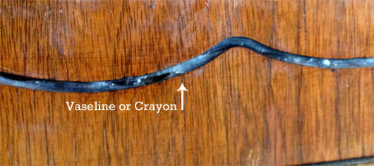 vaseline Vaseline or Crayon with arrow pointing at crevice in dresser