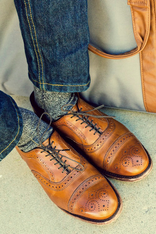 A man wearing Allen Edmonds Strands shoes with jeans