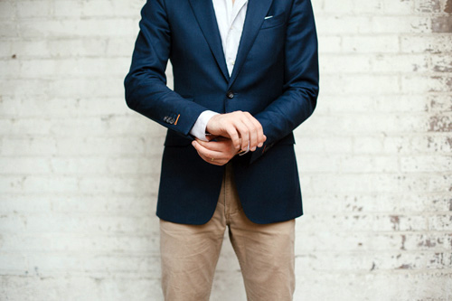 Man wearing nvy blazer and tan pants