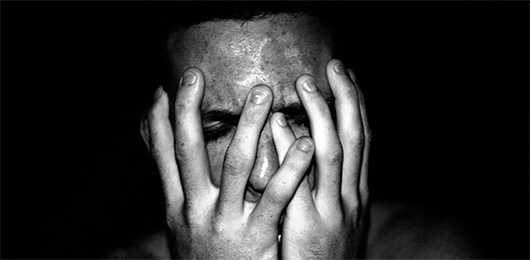 Man holding his face in his hands