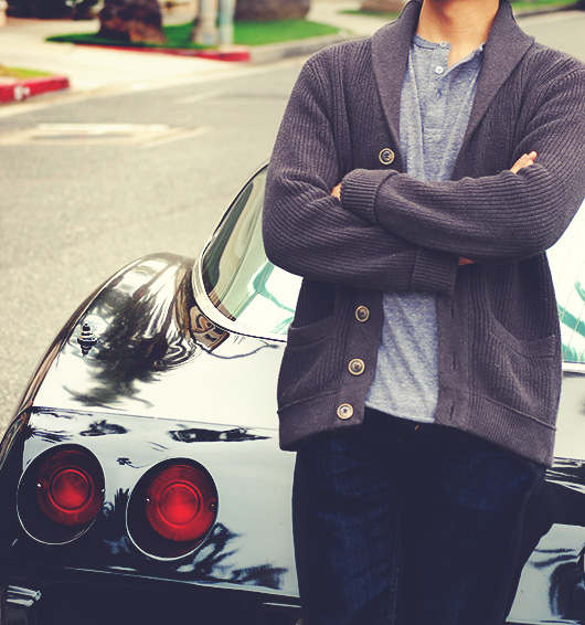 A man wearing a shawl cardigan sweater