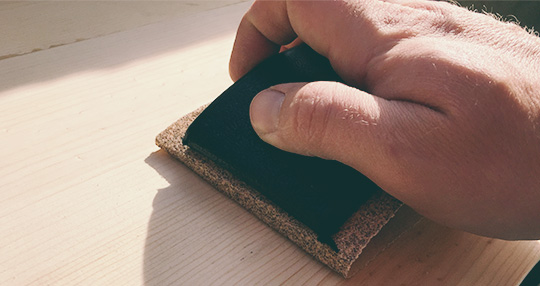 Sanding a piece of wood