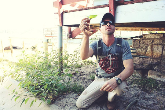 A survivalist holding a leaf