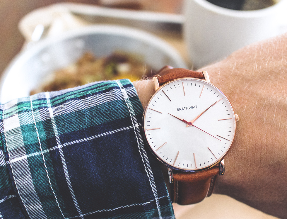 close up of rose gold watch on man's wrist