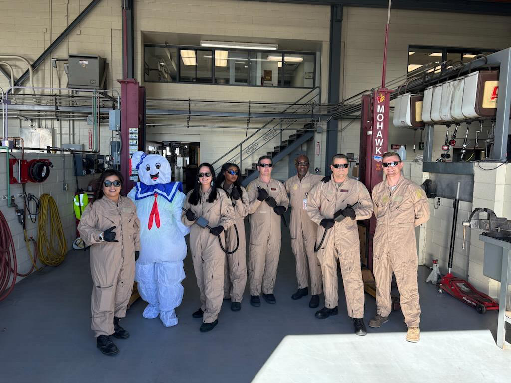 a group of people wearing DIY Ghostbuster halloween costumes