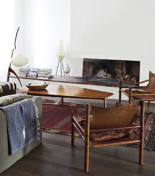 An eclectic living room filled with furniture and a table