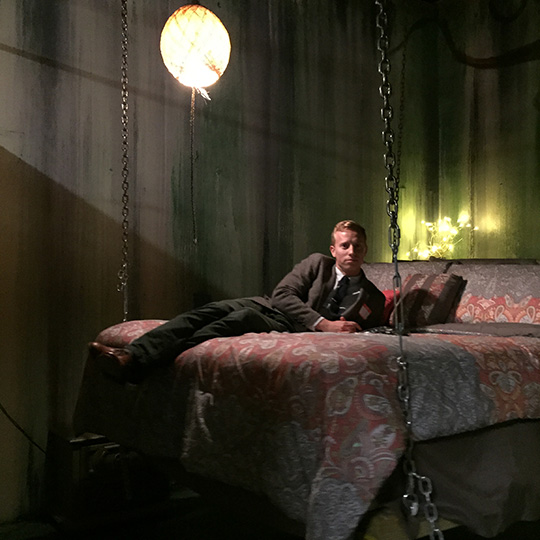 A man sitting on a bed