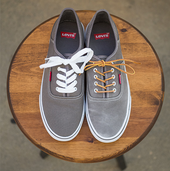 Gray canvas shoes sitting on stool