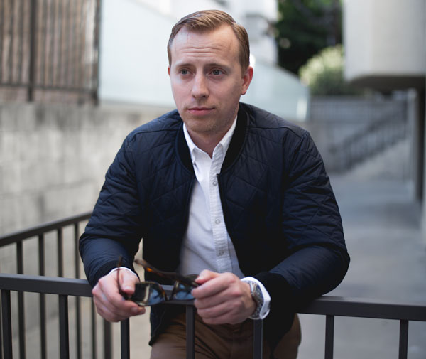 navy blue quilted bomber with white oxford shirt and khaki chinos men outfit