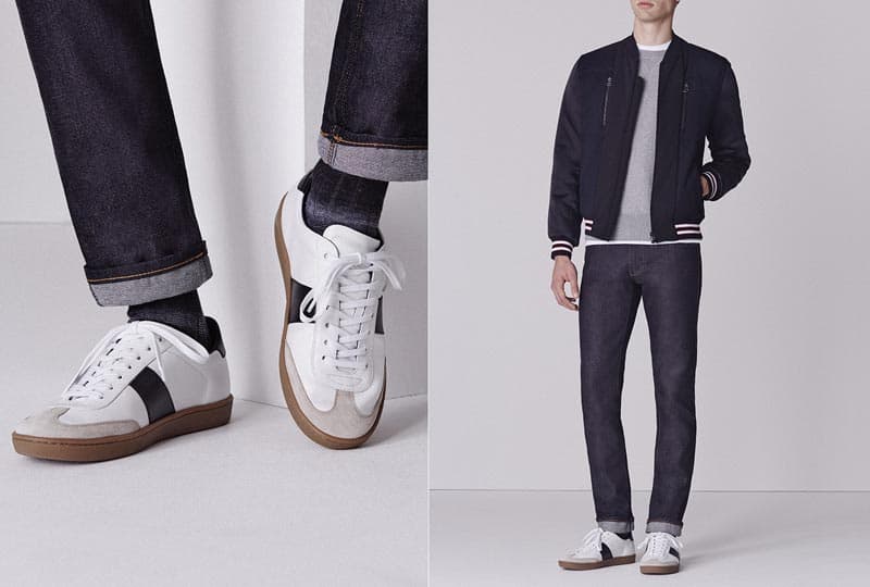 A man wearing a bomber jacket and sneakers