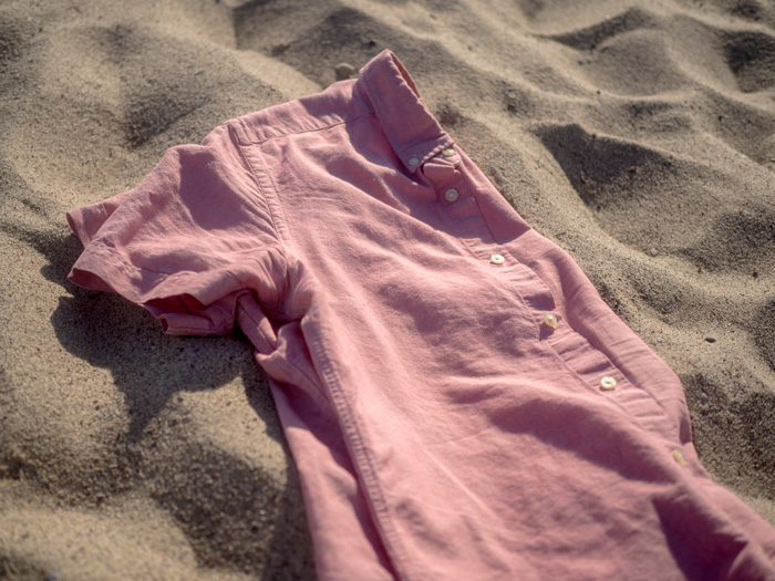 A red shirt lying on beach