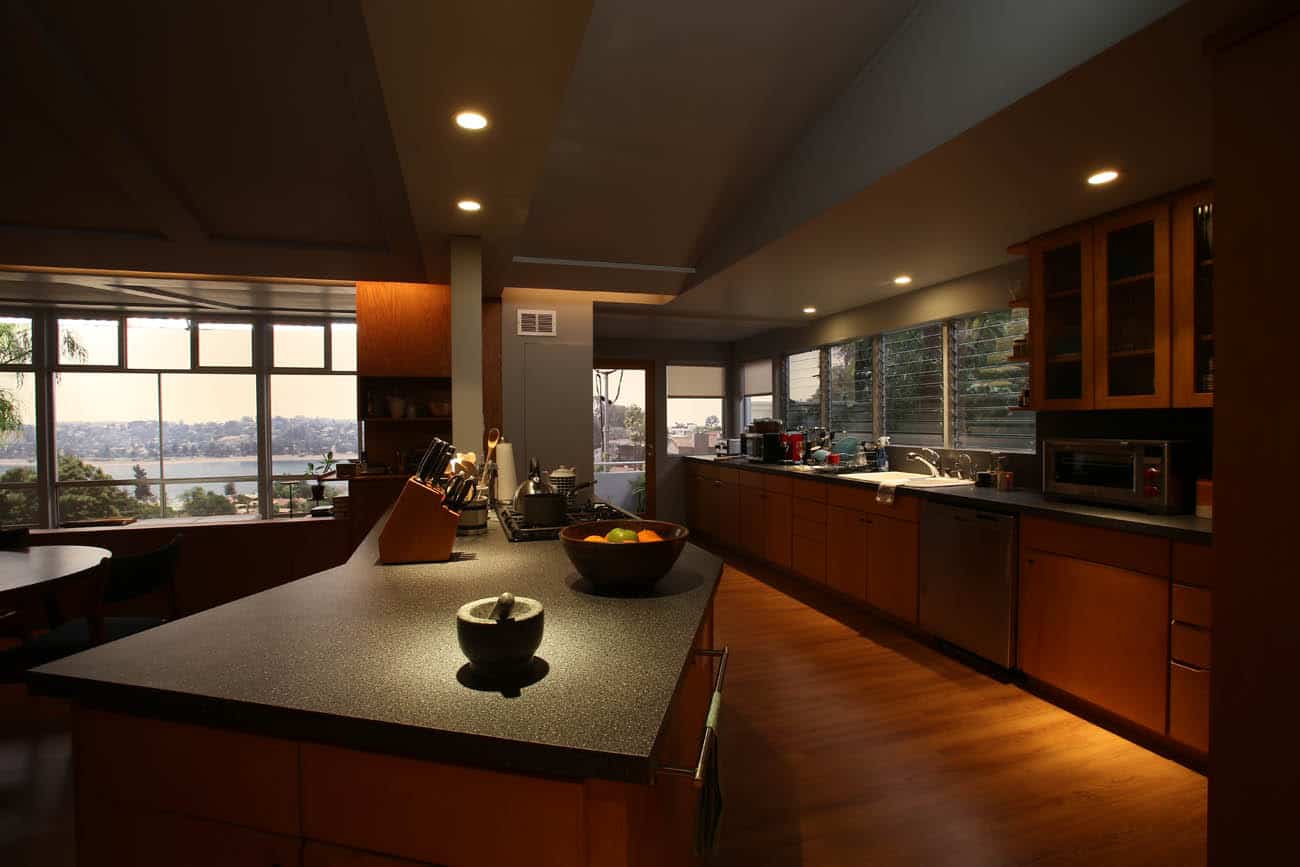 A modern kitchen with an island in the middle of a room