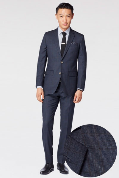 A man wearing a blue suit and tie