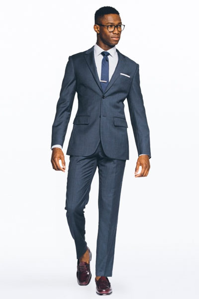 Man wearing blue suit and blue tie