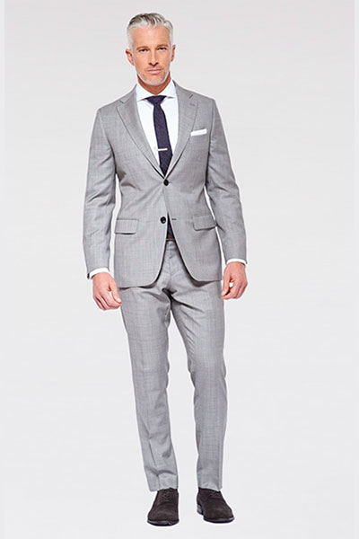 A man wearing a gray suit and tie