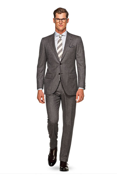 A man wearing a brown suit and tie