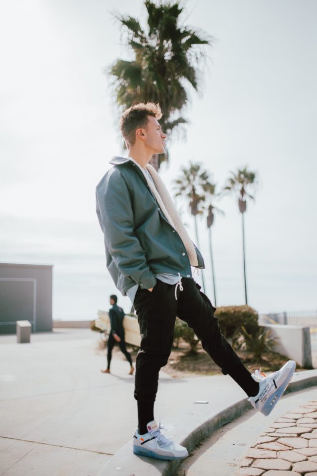 mens fashion silhouette - man on beach wearing baggy jacket with skinny pants