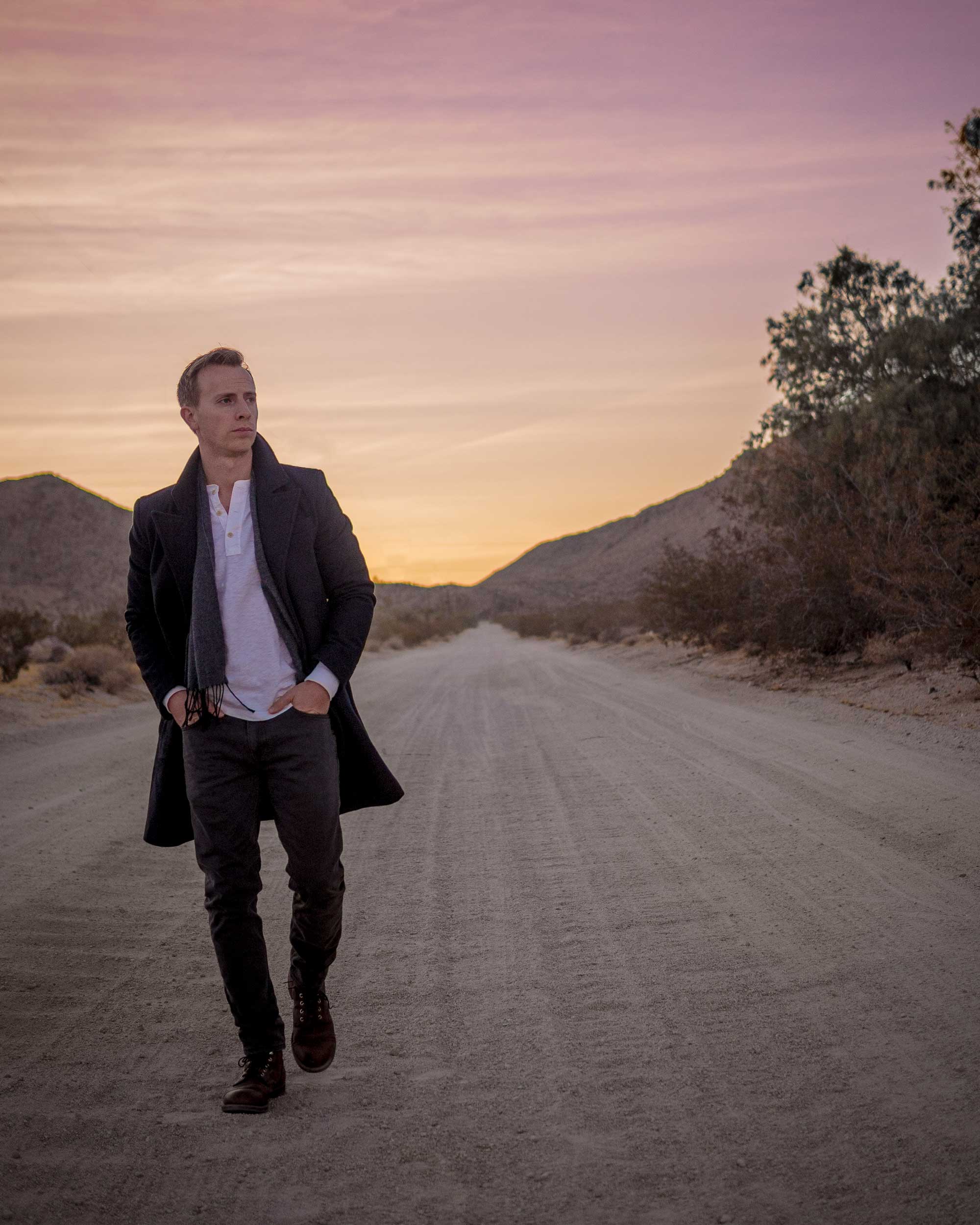 man walking along a road in Joshua Tree