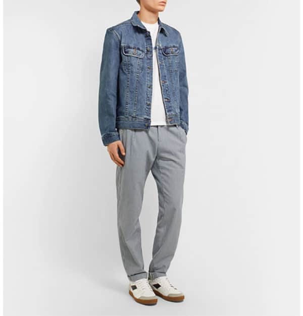 A man wearing sweat pants with jean jacket