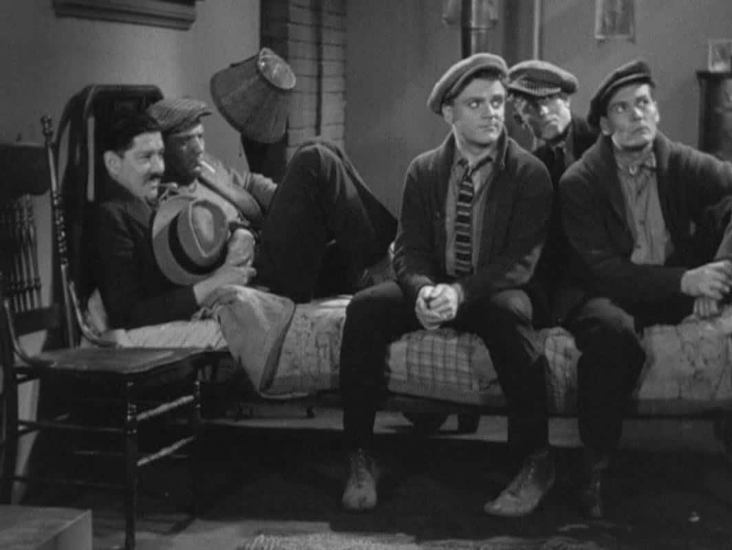 James Cagney sitting on a bed