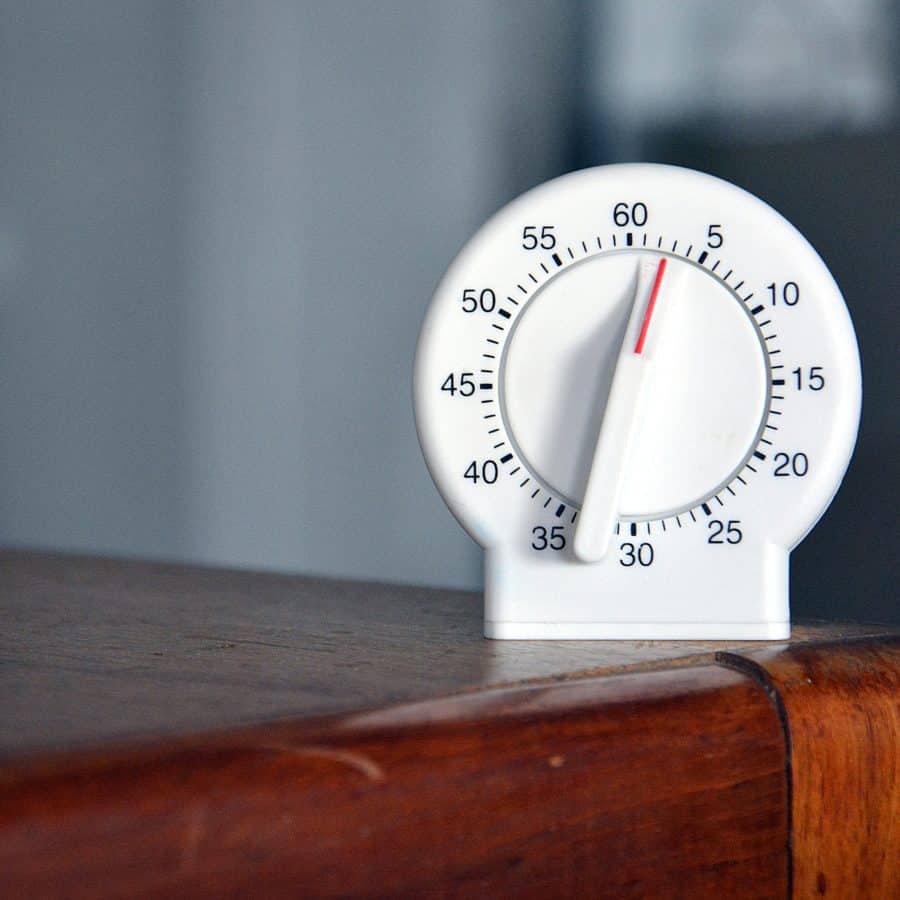 A timer sitting on top of a wooden table