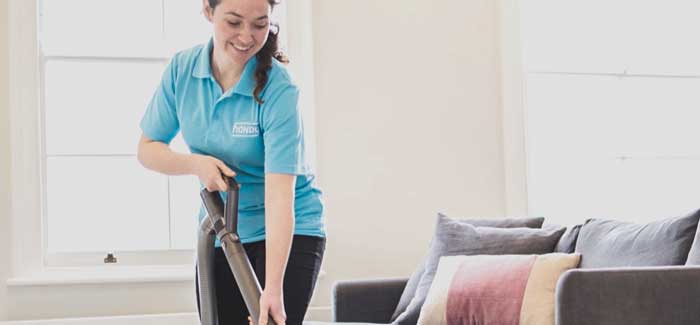 A woman vacuuming in a room
