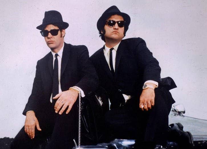 John Belushi wearing a suit and tie