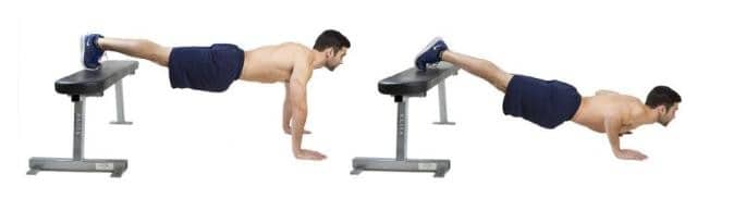Image of a man doing pushups using a gym bench