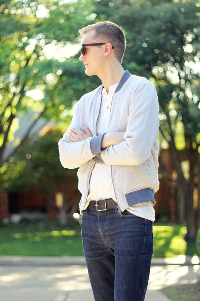man wearing bomber jacket and jeans