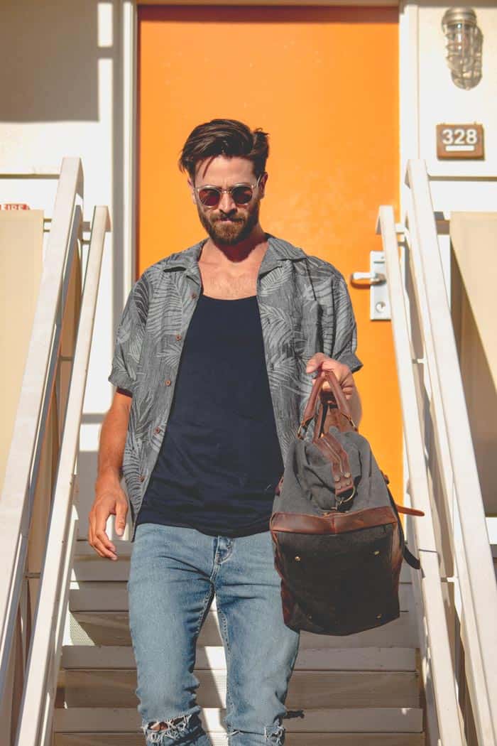A man walking down steps with floral shirt