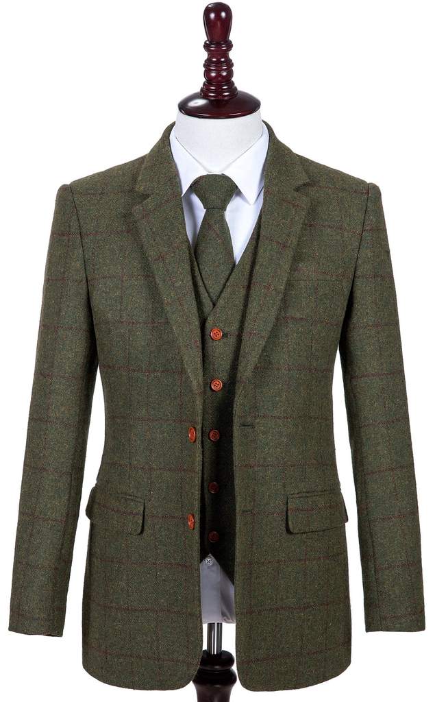 A man wearing a green tweed suit and tie