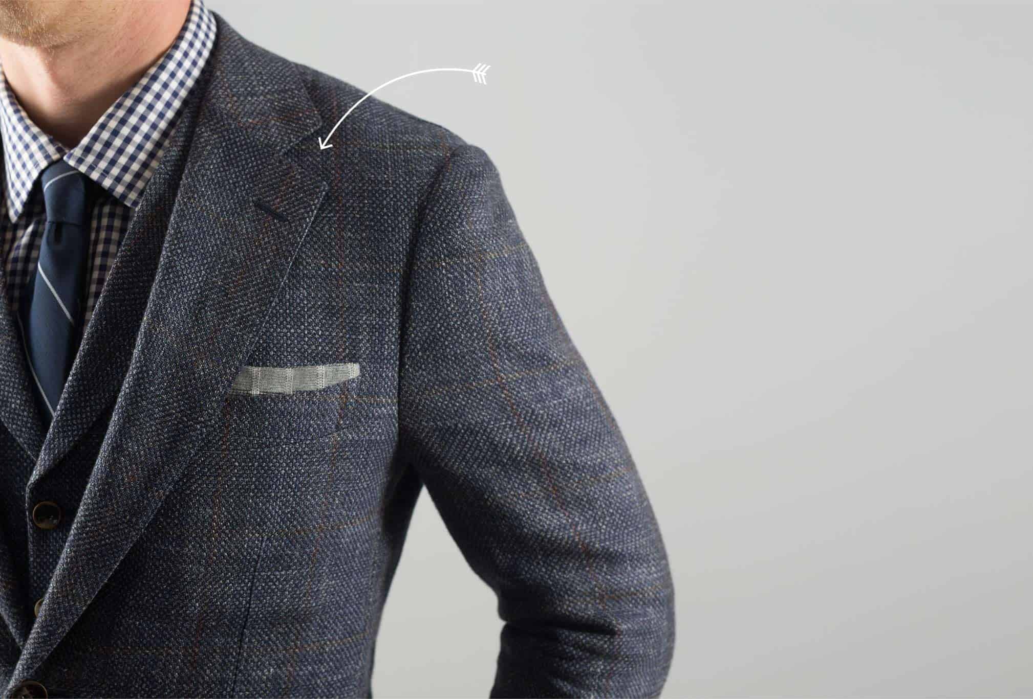 Arrow pointing at suit collar