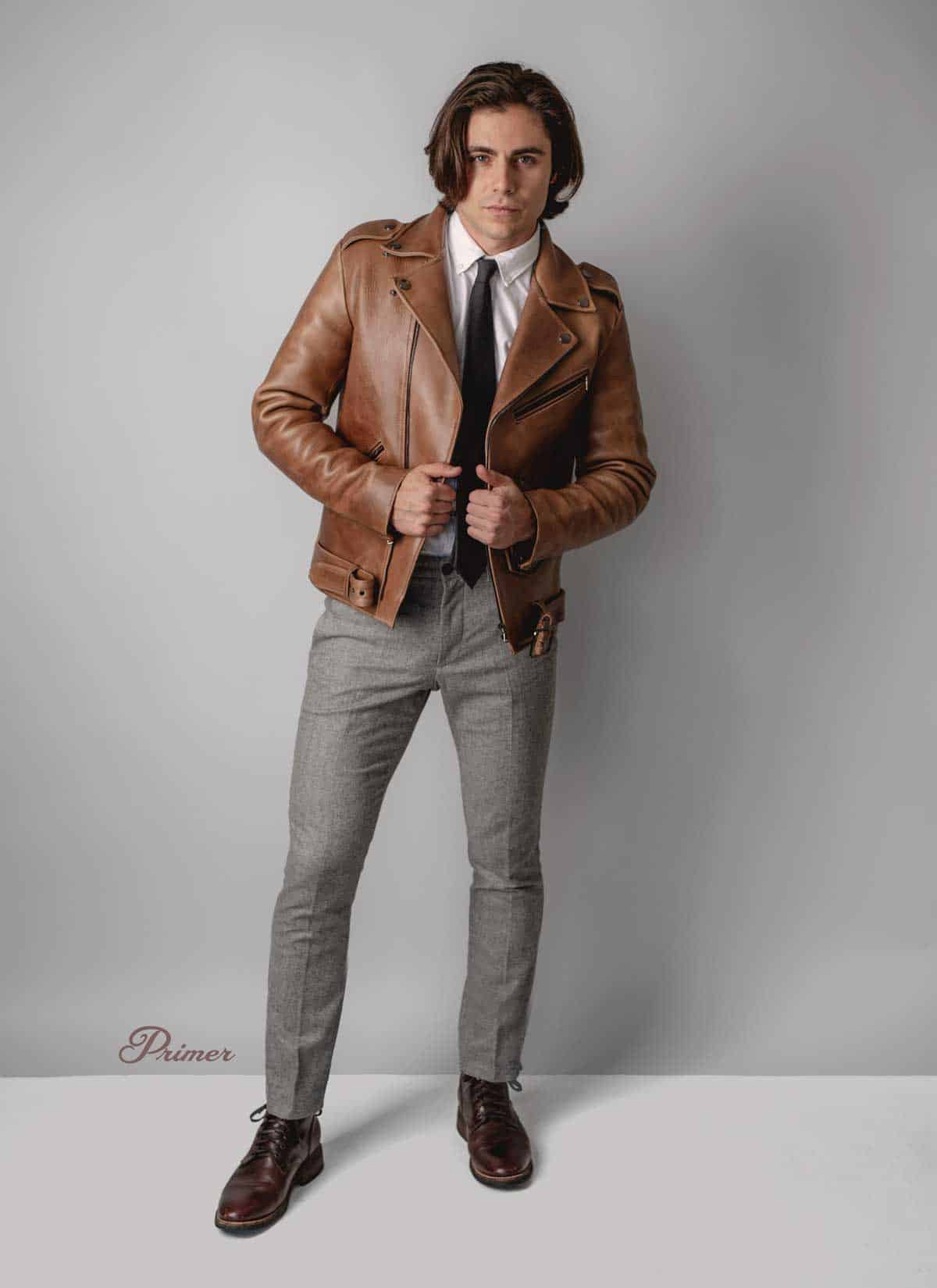 brown leather jacket with tie and gray dress pants