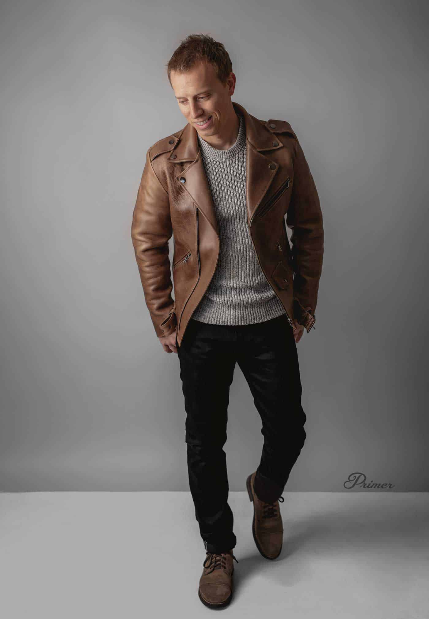 brown leather jacket men outfit inspiration gray sweater black jeans