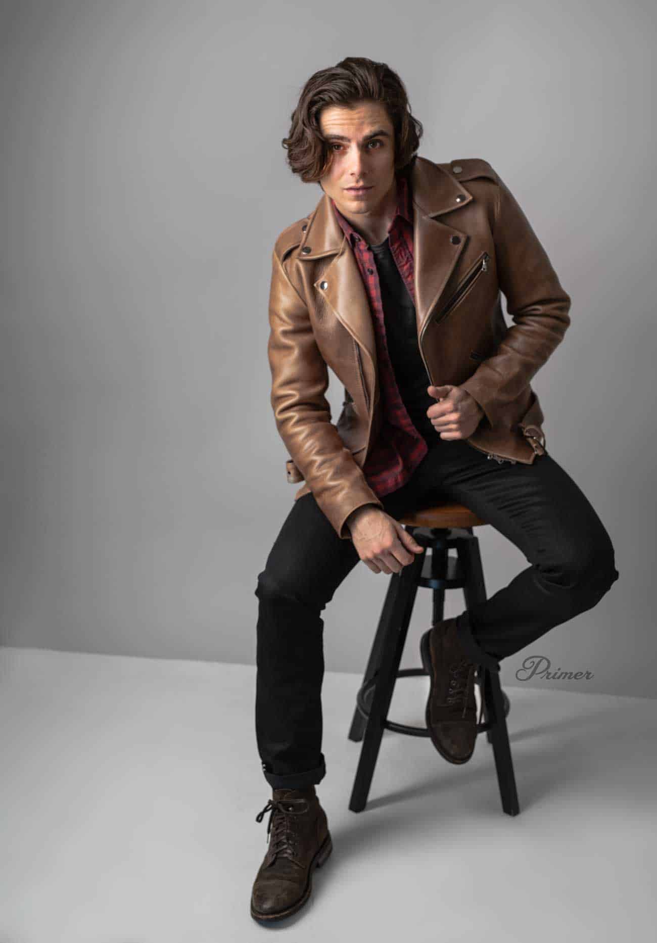 brown leather jacket with black jeans