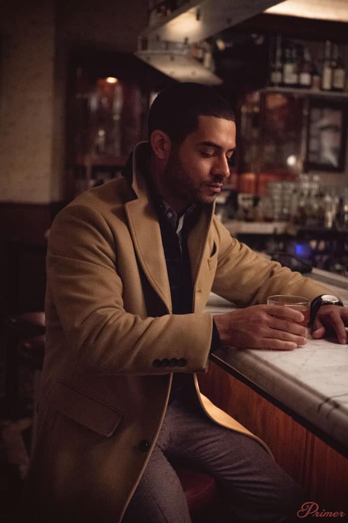 man wool topcoat having a drink winter style