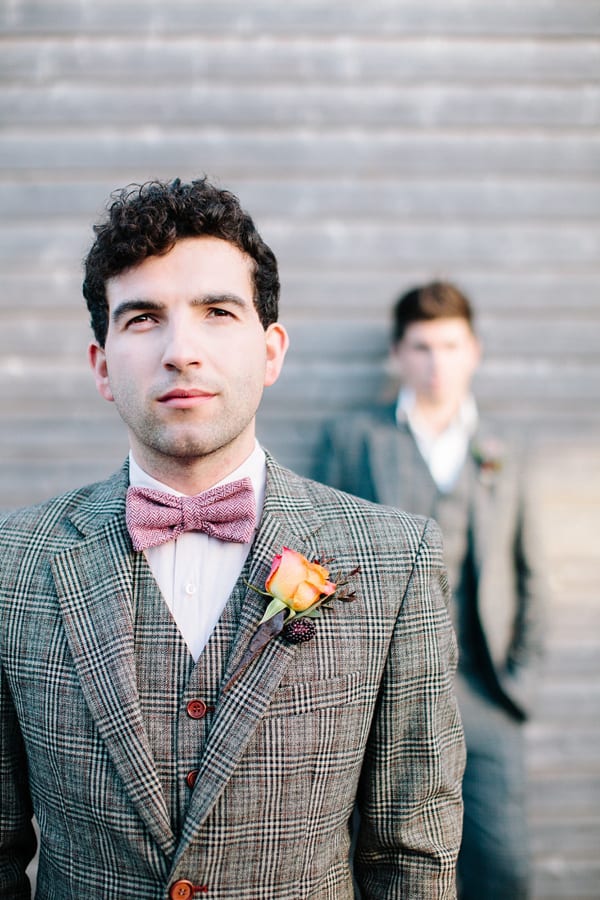 A man wearing a plaid suit and pink tie