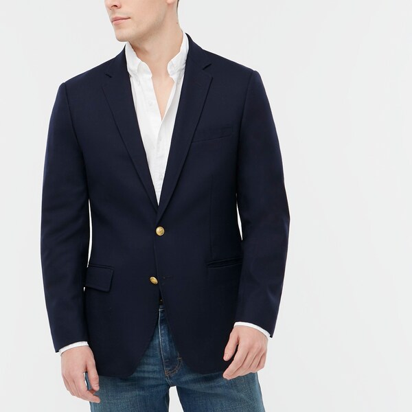a man wearing a navy blazer over a white button front shirt