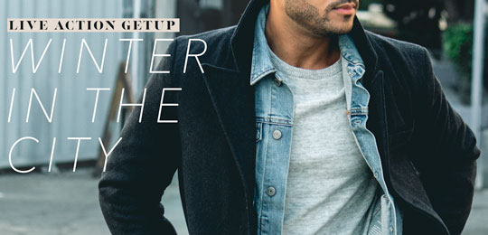 Closeup of a man wearing a denim jacket under a topcoat