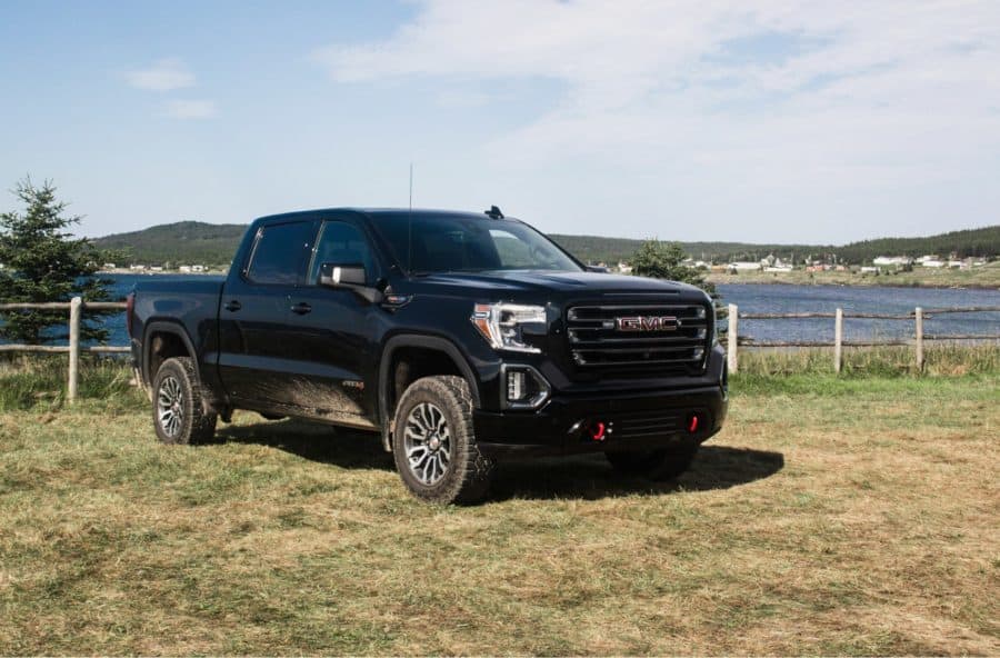 GMC2 DMC Sierra parked in field