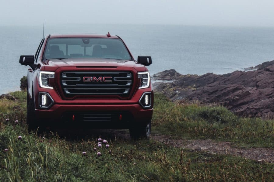 GMC8 A GMC SIerra parked next to a body of water