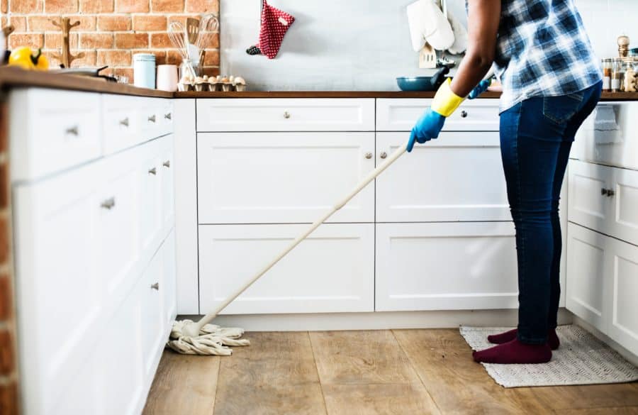 Image of person mopping the floor of a kitchen