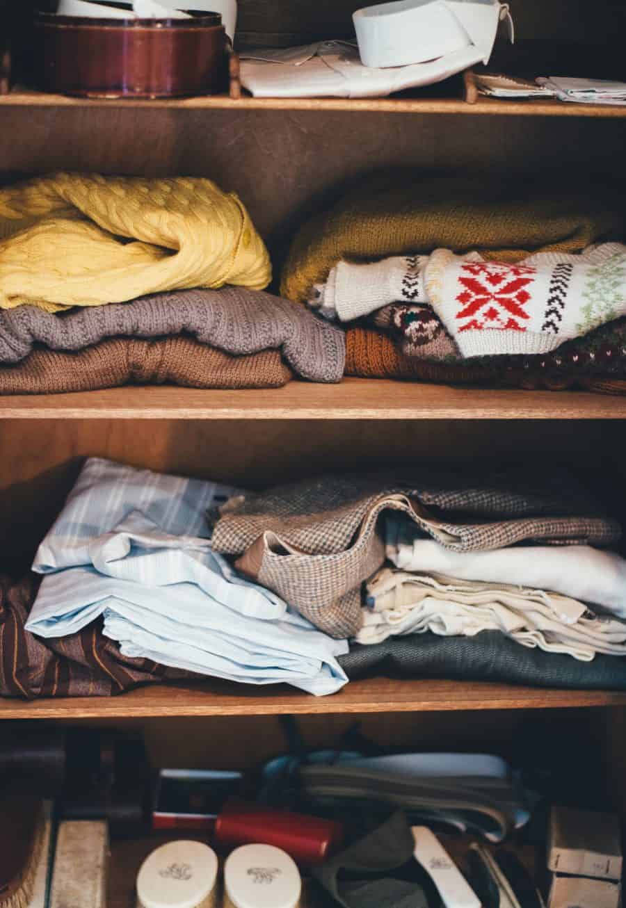 A bunch of clothing items that are on shelves