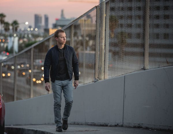 man tshirt gray jeans quilted bomber