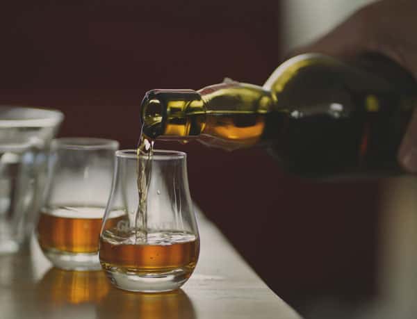 pouring scotch into a dram